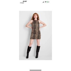 This is a Future Collective leopard print sleeveless mini dress made of 100% pol
